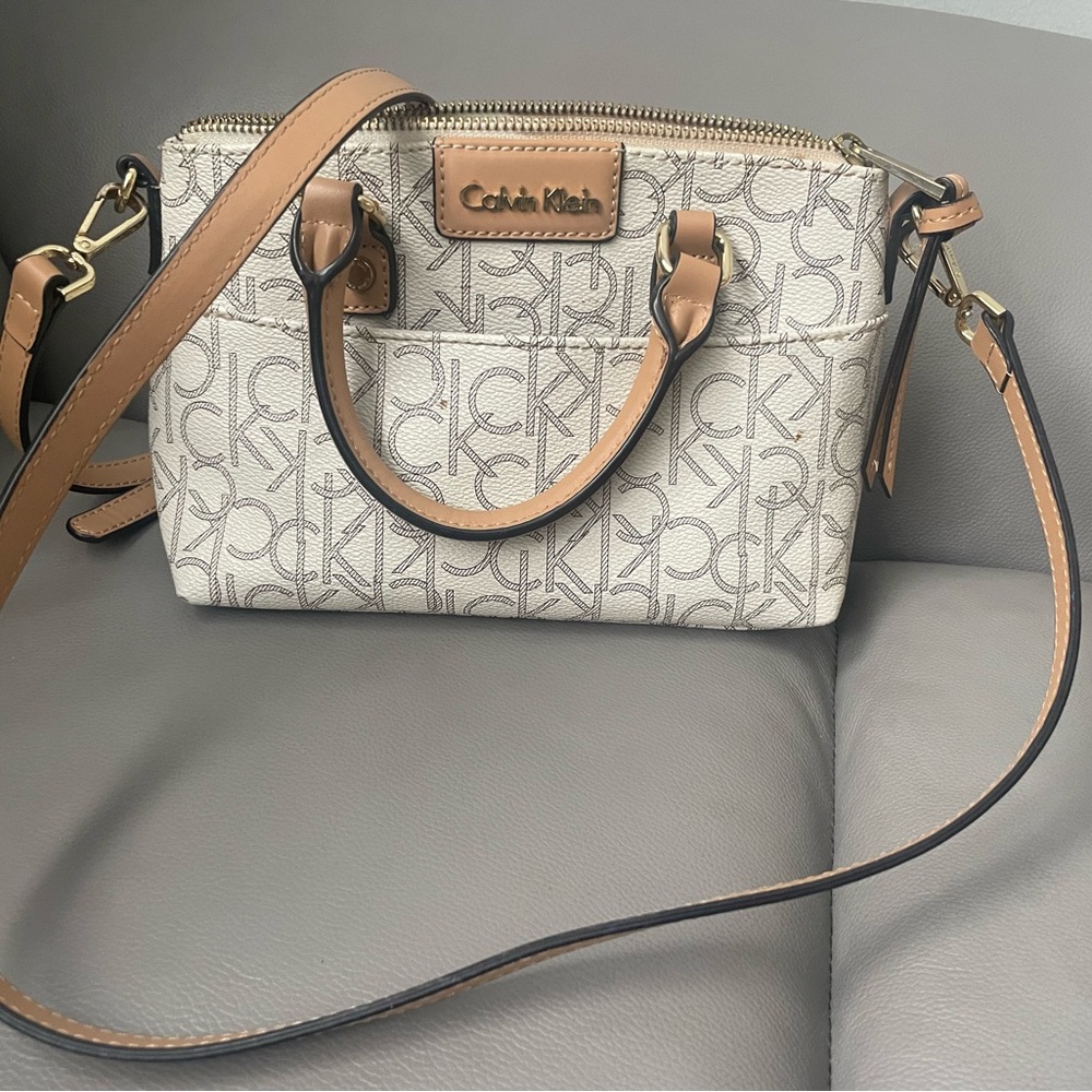 Calvin Klein Cream Monogram Crossbody 
8 1/2 inches long — 6 inches high